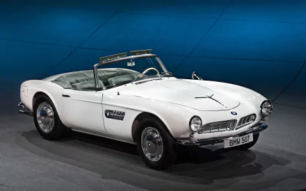 A classic white BMW 507 convertible displayed against a blue backdrop, featured as an HD PC desktop wallpaper and background.