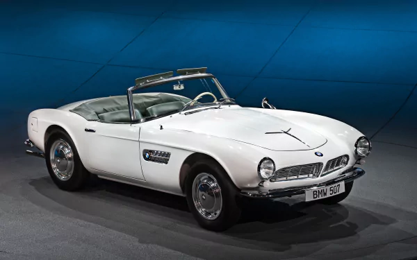 A classic white BMW 507 convertible displayed against a blue backdrop, featured as an HD PC desktop wallpaper and background.