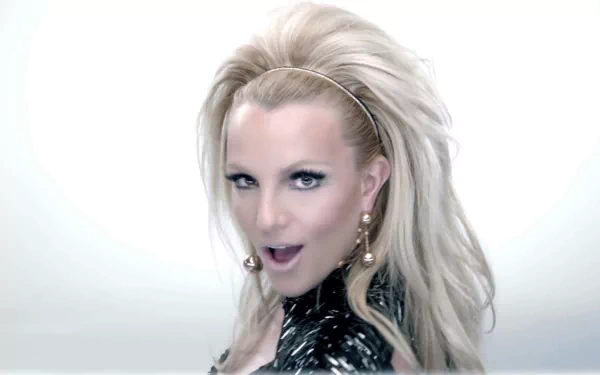 HD PC desktop wallpaper featuring Britney Spears in a music-themed image with a striking, glamorous look and platinum blonde hair.