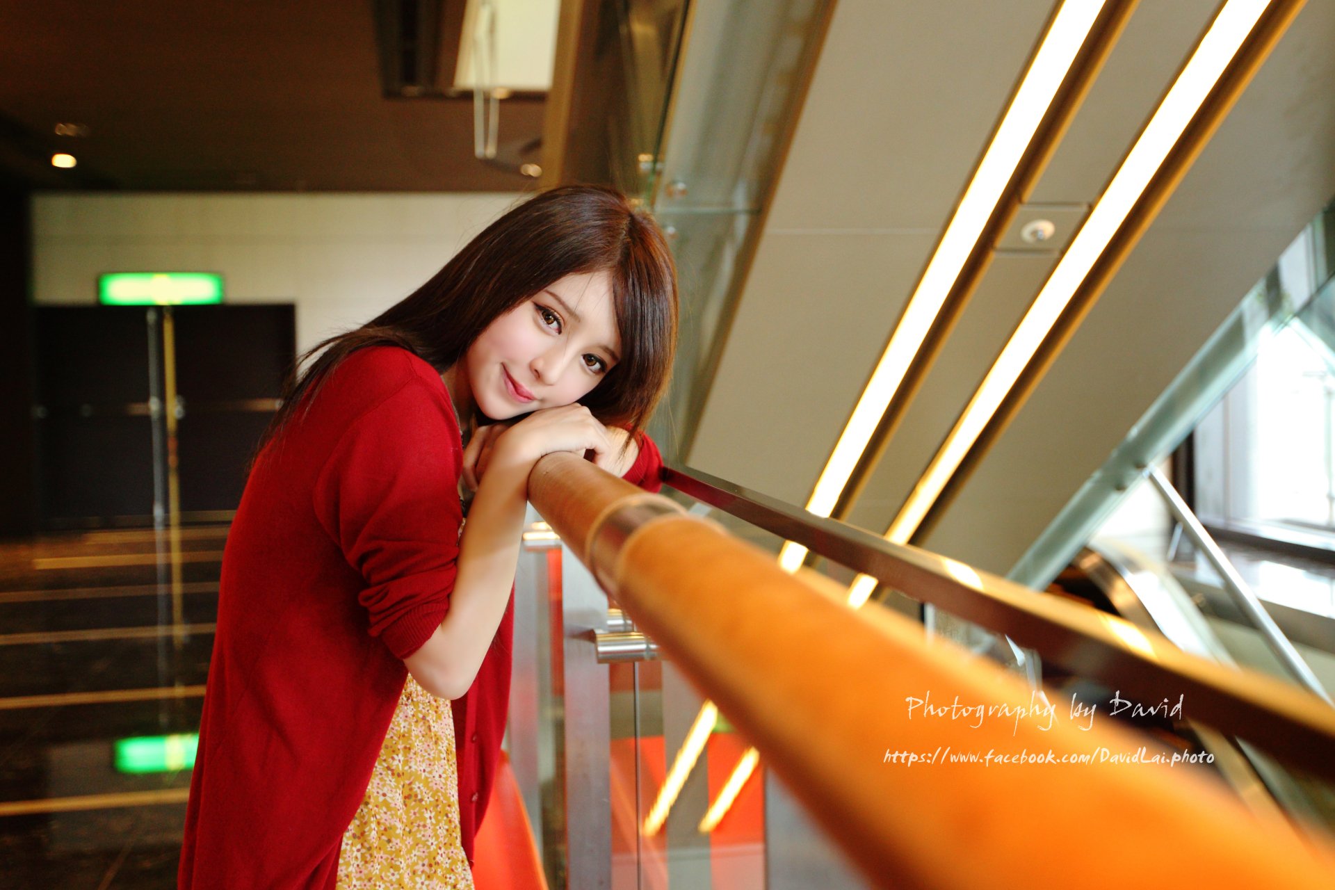 Taiwanese Asian model Julie Chang (Zhang Qi Jun) leans on a wooden railing in a softly lit indoor setting, captured in stunning 4K Ultra HD resolution.