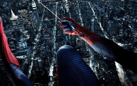 A striking HD wallpaper depicting Spider-Man from The Amazing Spider-Man movie, perched high above a vibrant city skyline at night, ready to swing into action.