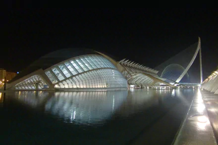 4K Ultra HD PC desktop wallpaper and background: man-made futuristic waterfront architecture at night, illuminated curved glass structures reflected in calm water.