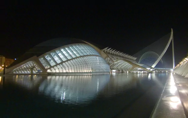 4K Ultra HD PC desktop wallpaper and background: man-made futuristic waterfront architecture at night, illuminated curved glass structures reflected in calm water.