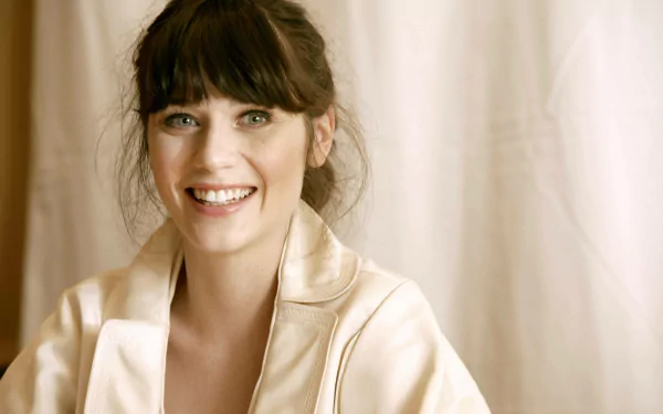 Smiling female celebrity with dark bangs in a satin robe against a soft neutral backdrop — 4K Ultra HD PC desktop wallpaper.