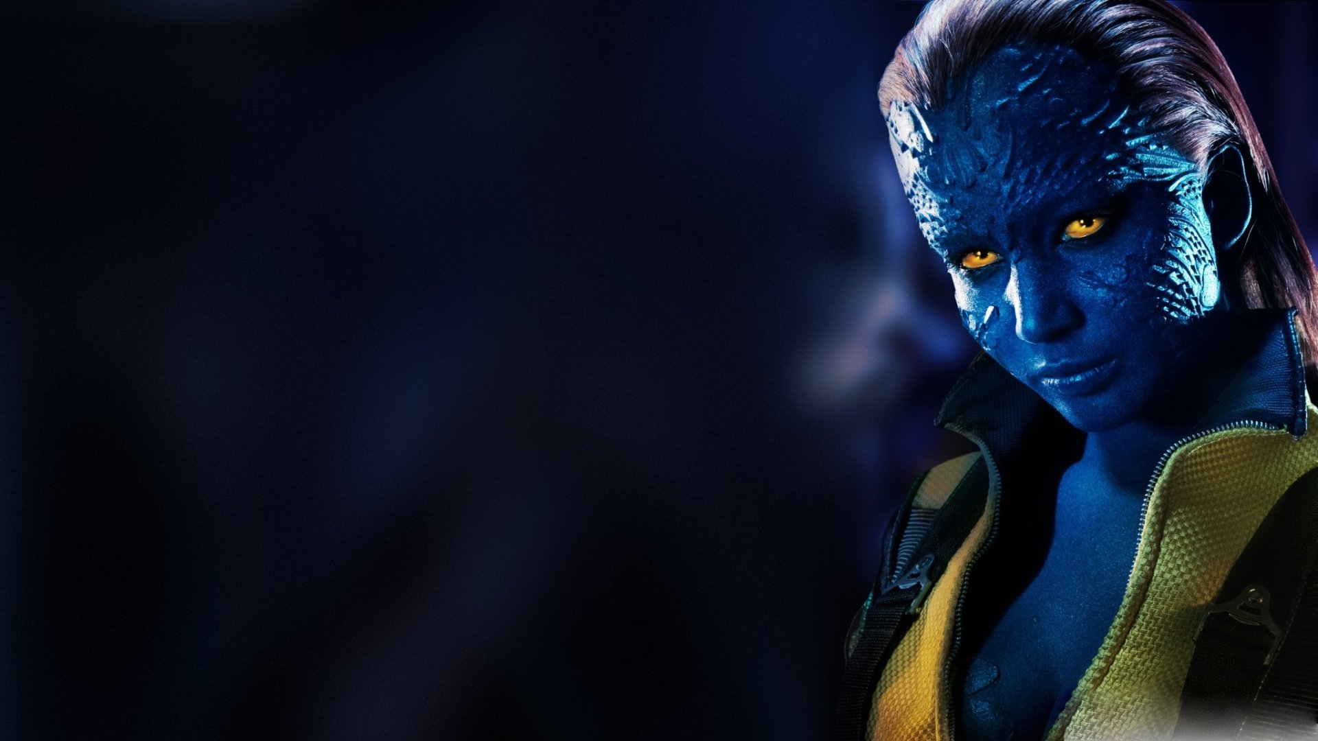 A striking HD wallpaper featuring a character from the X-Men movie series, showcasing vivid blue skin and intense yellow eyes in a dramatic pose against a dark background.