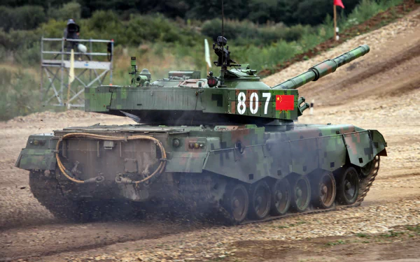Military HD PC desktop wallpaper/background showing a camouflaged Type 96 tank (807) kicking up dust on a dirt training track, three-quarter rear view.