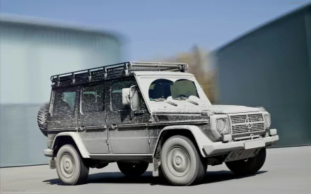 HD desktop wallpaper featuring a rugged Mercedes-Benz G-Class vehicle covered in dust, set against an industrial background.