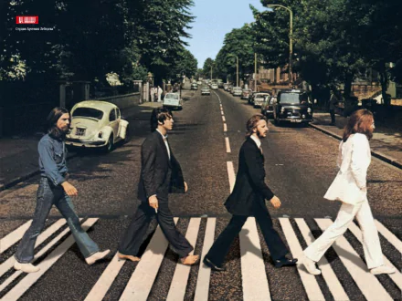 A high-definition wallpaper featuring The Beatles walking across Abbey Road, capturing a timeless moment in music history with a serene street scene in the background.