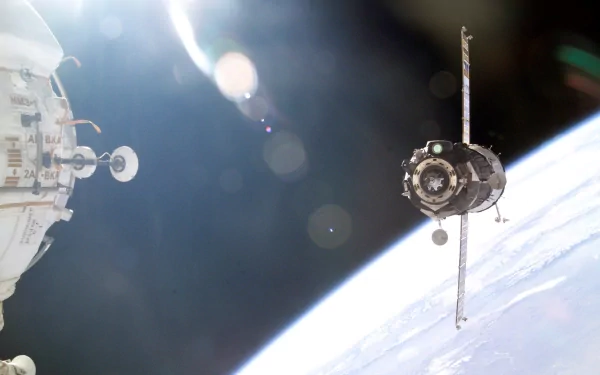 A stunning HD wallpaper showcasing a spacecraft in orbit around Earth, featuring NASA's man-made technology against the backdrop of space.