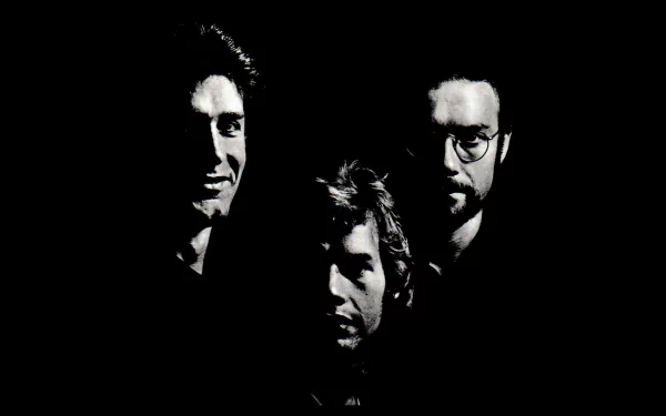 HD PC desktop wallpaper: three shadowed, high-contrast faces emerging from black, moody music-themed King Crimson aesthetic.