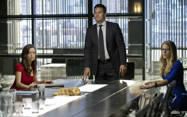 HD desktop wallpaper featuring Isabel Rochev, Felicity Smoak (Emily Bett Rickards), Summer Glau, and Stephen Amell from the TV show Arrow in a high-rise office setting.