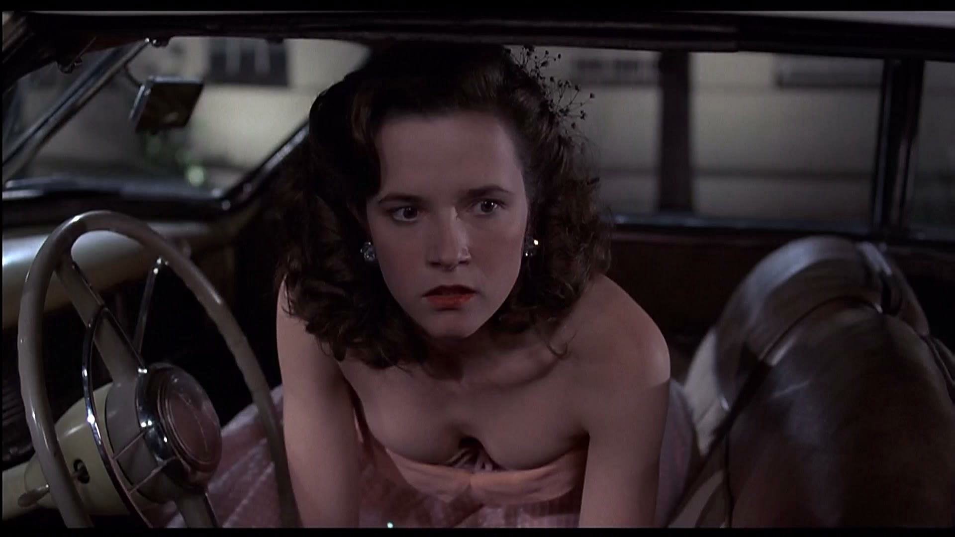 HD PC desktop wallpaper featuring a scene from the movie Back To The Future, showing a young woman seated inside a classic car, captured in cinematic detail.