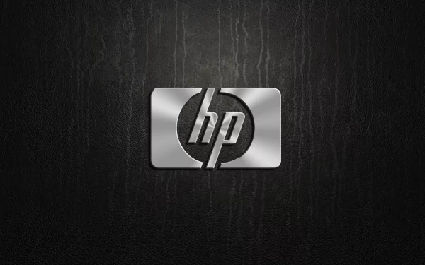 HP (Hewlett-Packard) brushed-metal emblem centered on a dark textured background — technology-themed HD PC desktop wallpaper.