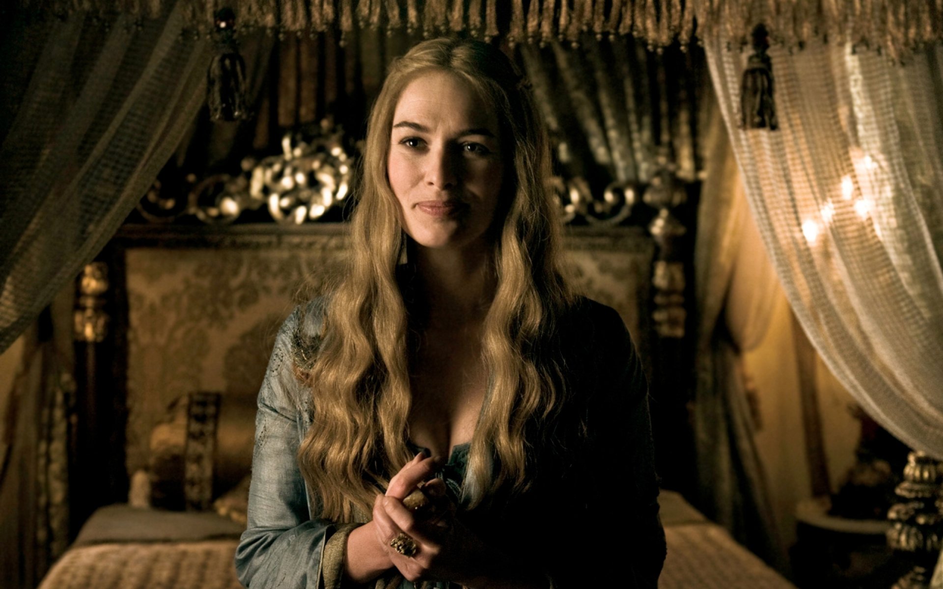 Regal woman with long blonde hair and ornate gown in a candlelit bedchamber, holding a ring — dramatic portrait-style 2K desktop wallpaper evoking a fantasy TV drama.