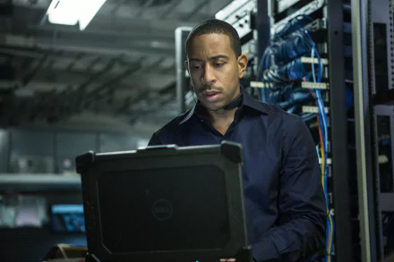 Ludacris as Tej in Furious 7, focused on a laptop amid a backdrop of server equipment, captures the high-stakes action of the Fast & Furious franchise. A dynamic HD wallpaper choice.
