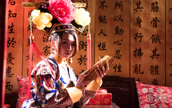A woman in traditional Taiwanese Chinese costume, identified as Qián Fūrén, holds a scroll against a backdrop of calligraphy in this 4K Ultra HD desktop wallpaper.