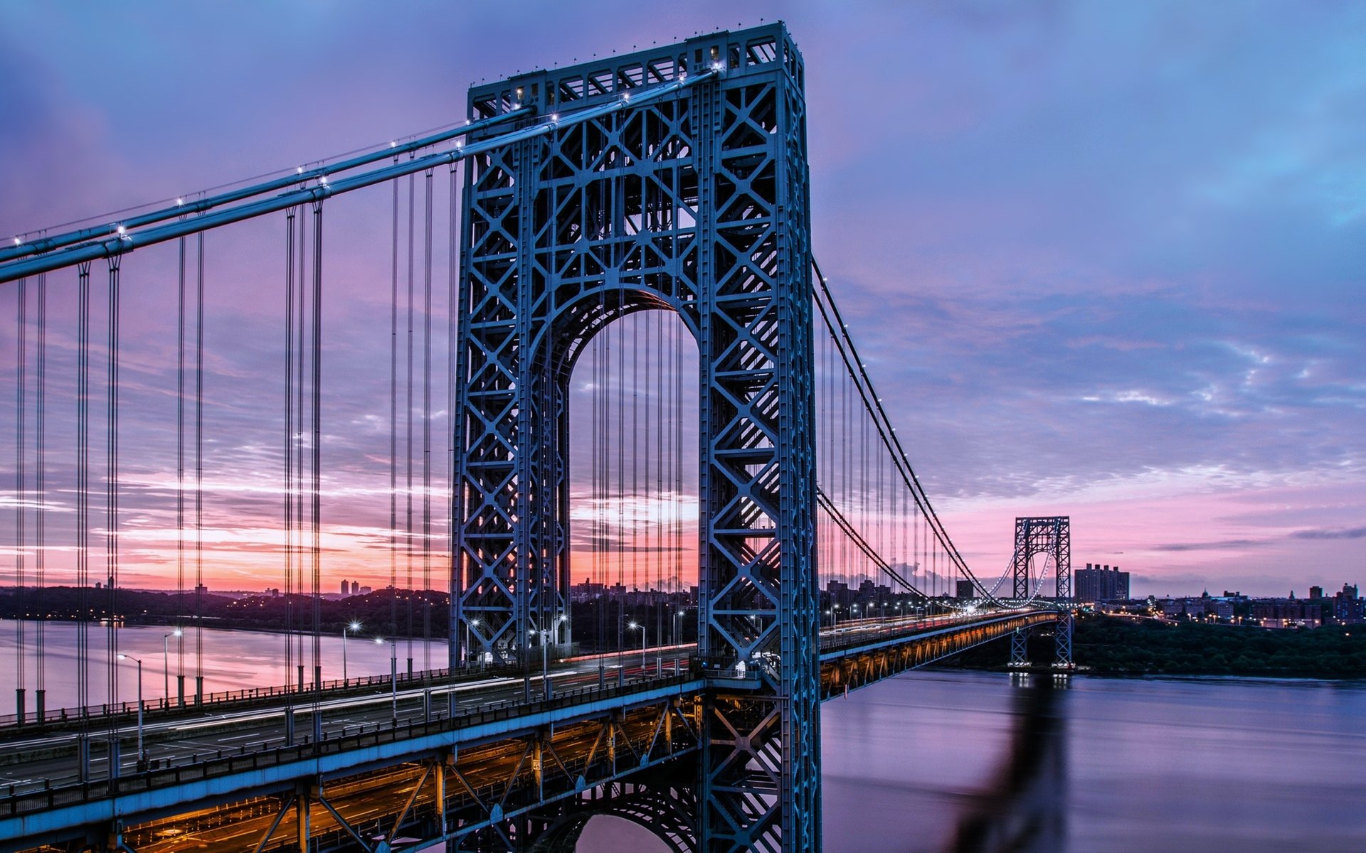 Night view of the illuminated George Washington Bridge spanning a river in New York, USA, captured in stunning 4K Ultra HD detail.