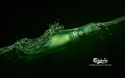 HD desktop wallpaper featuring a Carlsberg beer bottle submerged in water, showcasing the brand’s iconic green design with bubbles and ripples.