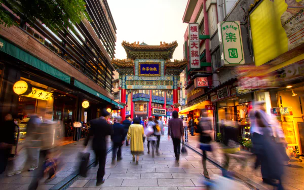 Blurred time-lapse crowd on a Yokohama Chinatown street in Kanagawa, Japan, vibrant lanterns and gate; 5K Ultra HD PC desktop wallpaper/background photography.
