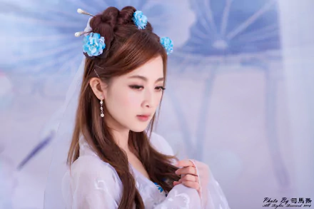 A Taiwanese woman with traditional Chinese hairpins and earrings, styled hair, and delicate makeup, captured in a serene 4K Ultra HD portrait background.