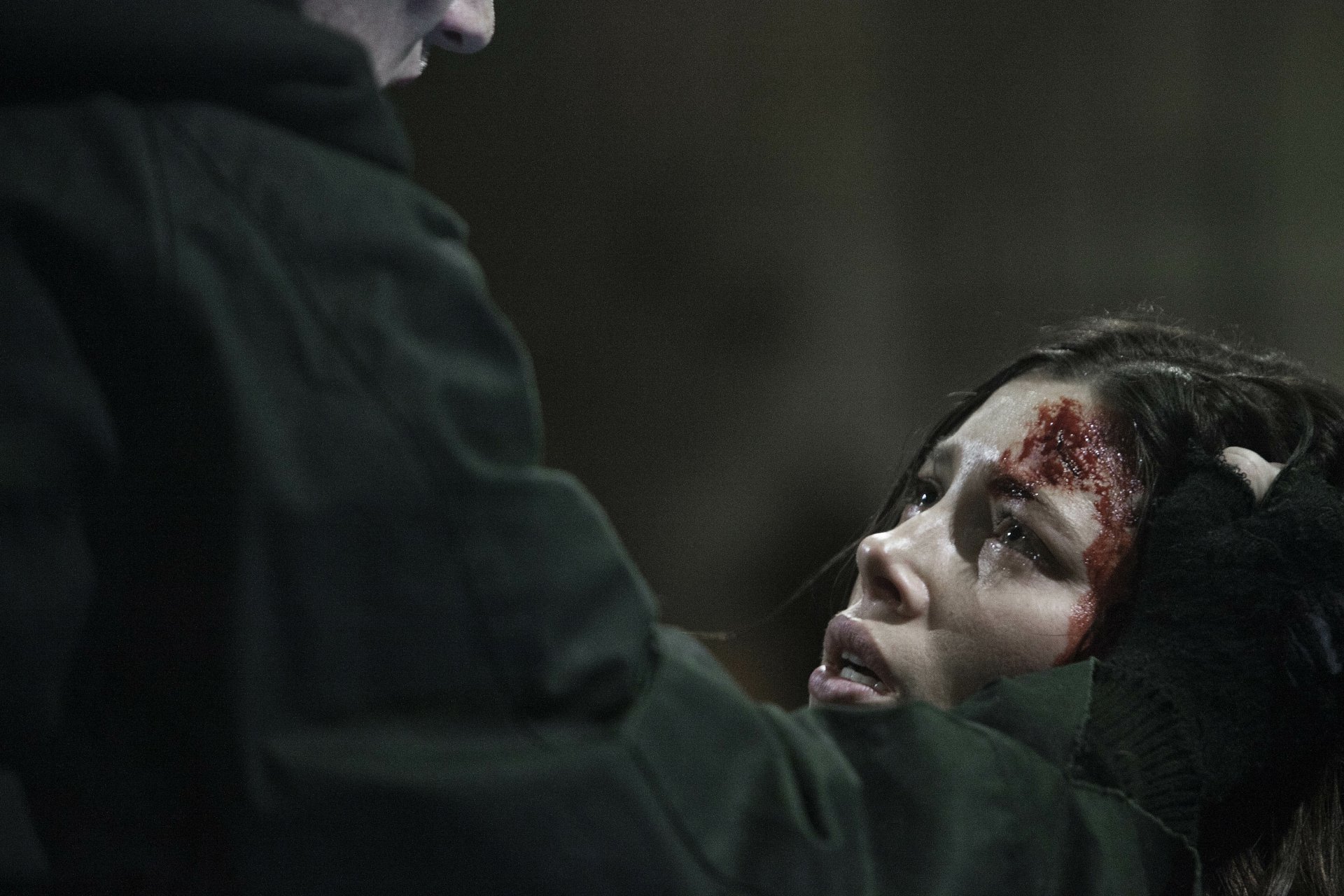 Scene from the movie The Tall Man featuring Jessica Biel with blood on her forehead, captured in a dark, intense moment; 4K Ultra HD PC desktop wallpaper and background.