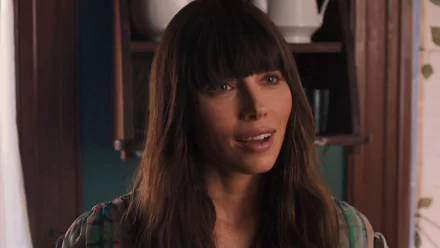 HD desktop wallpaper featuring Jessica Biel from the movie The Truth About Emanuel, showcasing her with long dark hair and bangs in a warm indoor setting.