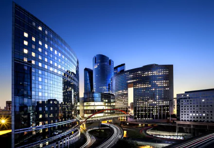 4K Ultra HD view of La Défense in Paris, France, featuring modern man-made skyscrapers illuminated at twilight.