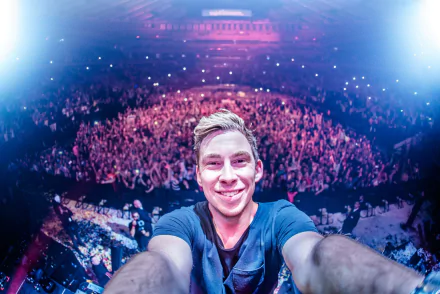 HD PC desktop wallpaper featuring DJ Hardwell taking a selfie in front of a massive, energetic crowd at a live music event.