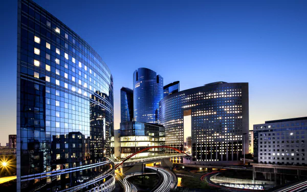 4K Ultra HD view of La Défense in Paris, France, featuring modern man-made skyscrapers illuminated at twilight.