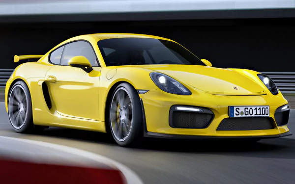 A vibrant yellow Porsche Cayman GT4 racing around a track, showcasing its sleek design and dynamic performance in a high-definition background.