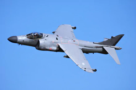 A British Aerospace Sea Harrier FA2 military warplane in flight against a clear blue sky, captured in 4K Ultra HD for desktop wallpaper.