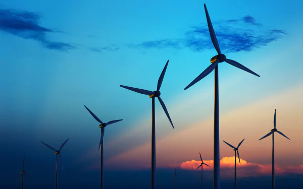 A stunning HD desktop wallpaper featuring towering wind turbines against a vibrant sunset sky, showcasing the beauty of man-made renewable energy.