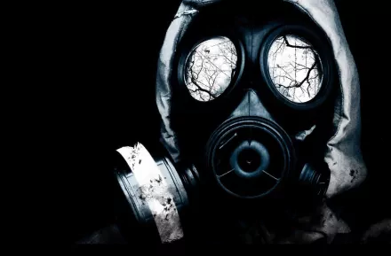 HD desktop background featuring a dark image of a person in a gas mask. The lenses of the mask reflect eerie, leafless tree branches.
