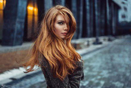 HD desktop wallpaper featuring a redheaded woman, tagged as a model, standing on a cobblestone street with a dark, blurred urban background.