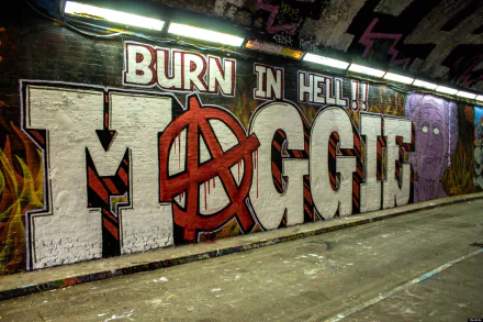 Dark HD PC desktop background of gritty tunnel graffiti reading BURN IN HELL MAGGIE with a red anarchy A painted into the lettering.