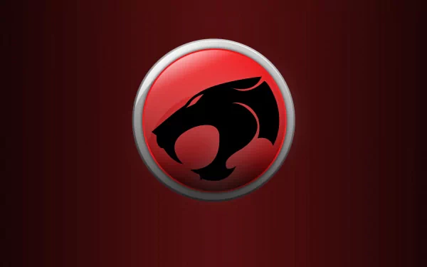 A bold HD wallpaper featuring the iconic emblem of Thundercats (1985) against a deep red background, capturing the essence of the classic TV show.