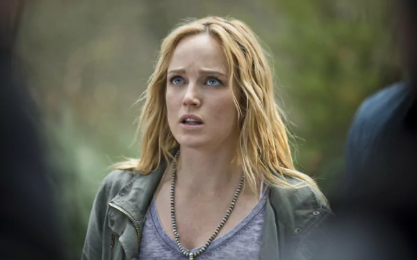 HD desktop wallpaper featuring Caity Lotz as seen in the TV show Arrow, capturing an intense moment with her expressive gaze and natural setting.