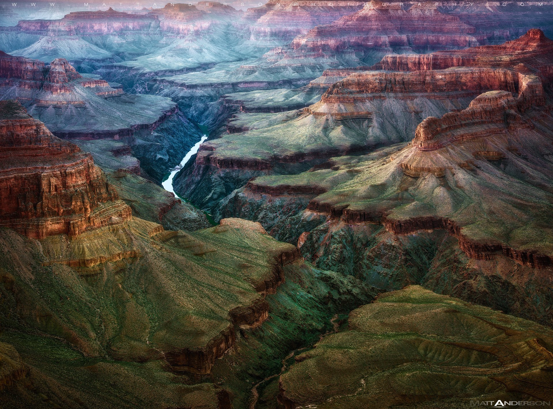 A stunning HD view of the Grand Canyon at dusk, showcasing majestic cliffs and a winding river, capturing the natural beauty of Arizona's landscape.
