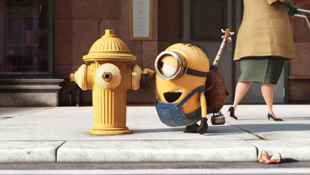 HD wallpaper of Stuart the Minion from the movie Minions touching a yellow fire hydrant on a city sidewalk.