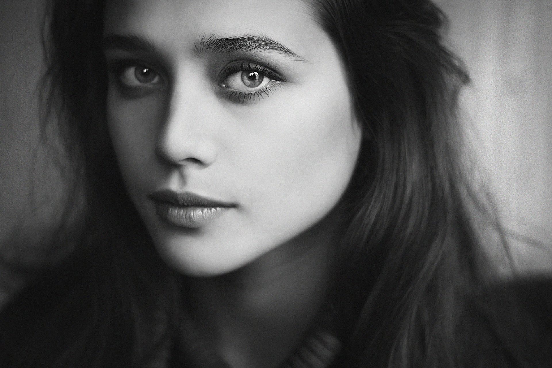 A striking black and white portrait of a woman, capturing her expressive face and intense gaze, suitable as an HD desktop wallpaper or background.