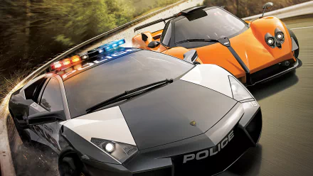 HD PC desktop wallpaper featuring a high-speed chase scene from the video game Need For Speed: Hot Pursuit with a police car pursuing an orange supercar.