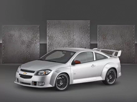 HD PC desktop wallpaper featuring a silver Chevrolet Cobalt sports car against a textured industrial backdrop.