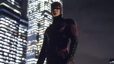 Daredevil from the TV show stands in his dark suit against a backdrop of illuminated skyscrapers, presented as a high-resolution 4K Ultra HD PC desktop wallpaper.