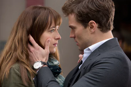 HD desktop wallpaper featuring Jamie Dornan and Dakota Johnson in a scene from the movie Fifty Shades of Grey, showing an intense, close-up moment between the characters.