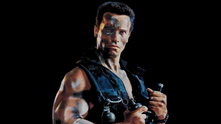 A dynamic HD wallpaper featuring a muscular action hero from the movie Commando, ready for battle with weapons and an intense expression against a dark background.