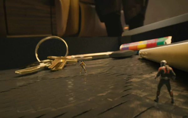 A vibrant HD desktop wallpaper featuring characters from Ant-Man, set against a backdrop of everyday objects like keys and colorful pens, emphasizing their miniature scale.