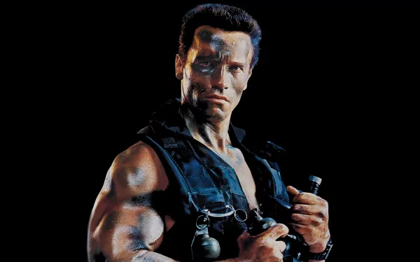 A dynamic HD wallpaper featuring a muscular action hero from the movie Commando, ready for battle with weapons and an intense expression against a dark background.