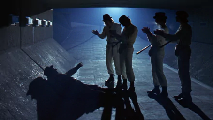 HD PC desktop wallpaper/background from the movie A Clockwork Orange: silhouetted droogs in bowler hats and white outfits surround a fallen figure in a dim, blue-lit tunnel.