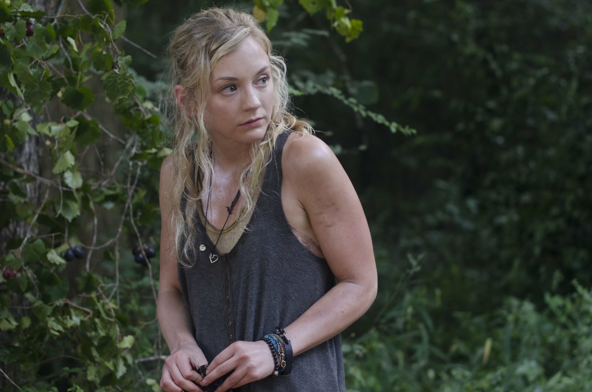 HD PC desktop wallpaper featuring a character from the TV show The Walking Dead standing in a forested area with a thoughtful expression.