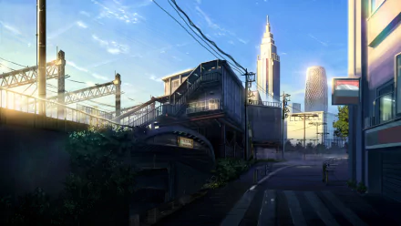 An anime-style cityscape featuring skyscrapers under a clear sky with clouds. Sunlight illuminates the landscape, creating a vivid and atmospheric HD wallpaper.